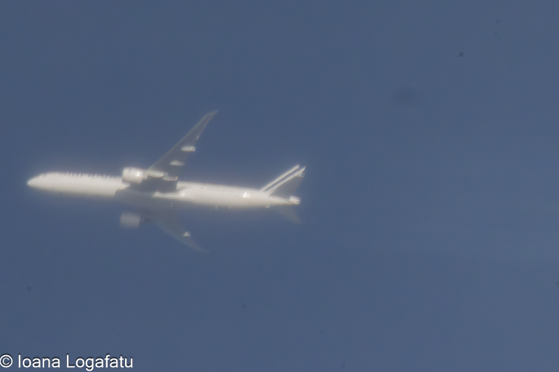 Airplane soaring through a clear blue sky above